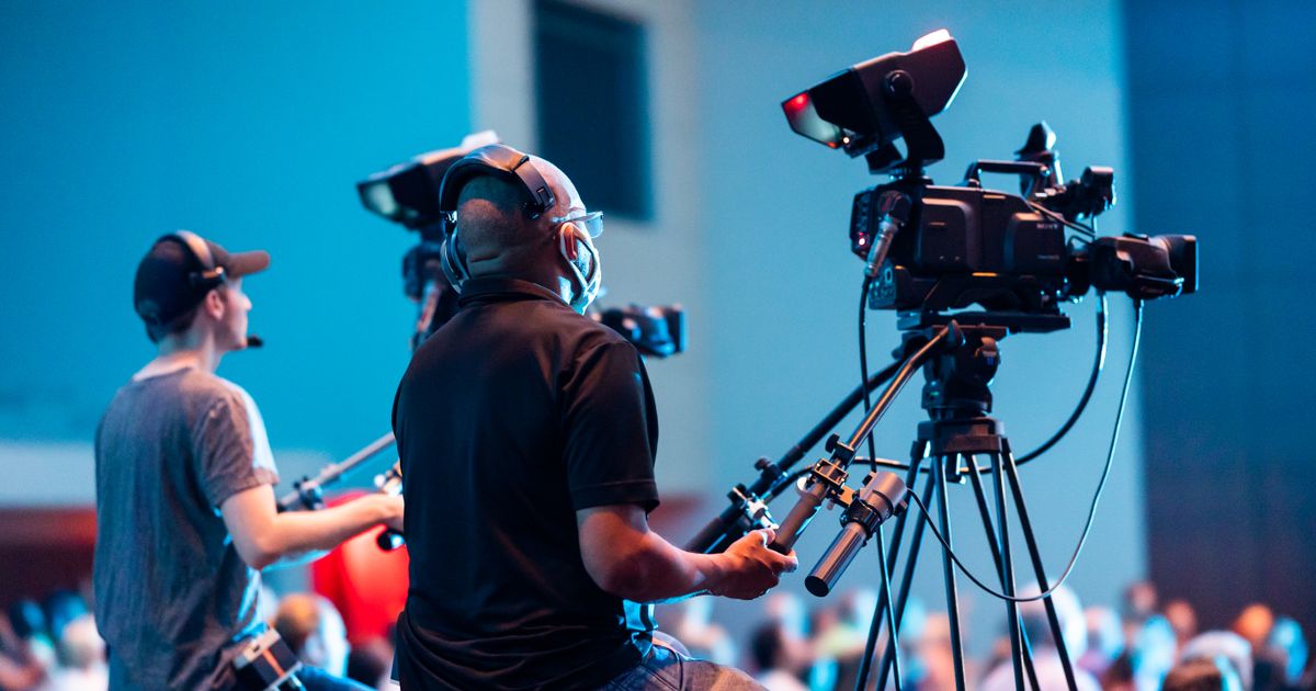 Dallas event video production — two camera operators filming a general session by Tone Films