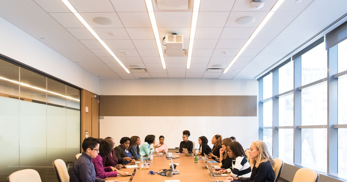 Colleagues in a conference room during a Seattle internal communications video session