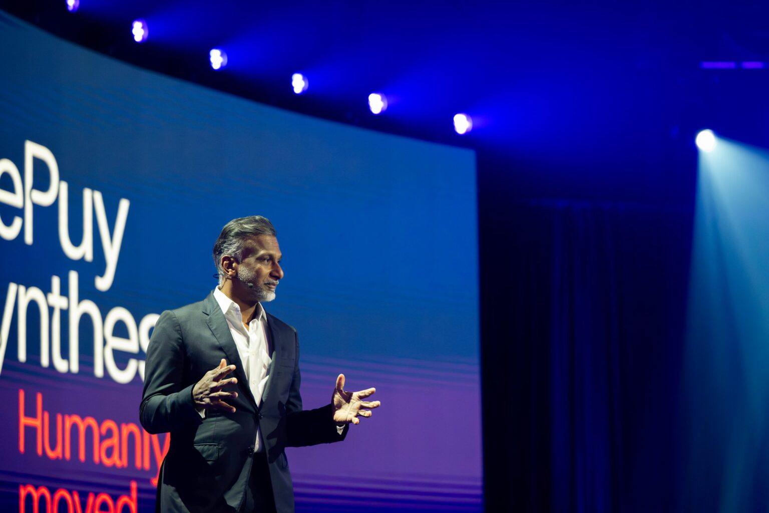 DePuy Synthes executive on stage at the Hyatt Regency Dallas plenary, filmed by Tone Films for corporate event video production