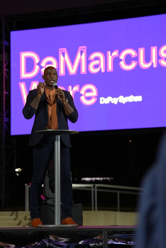 DeMarcus Ware speaking at the DePuy Synthes evening event at AT&T Stadium, corporate event video production by Tone Films