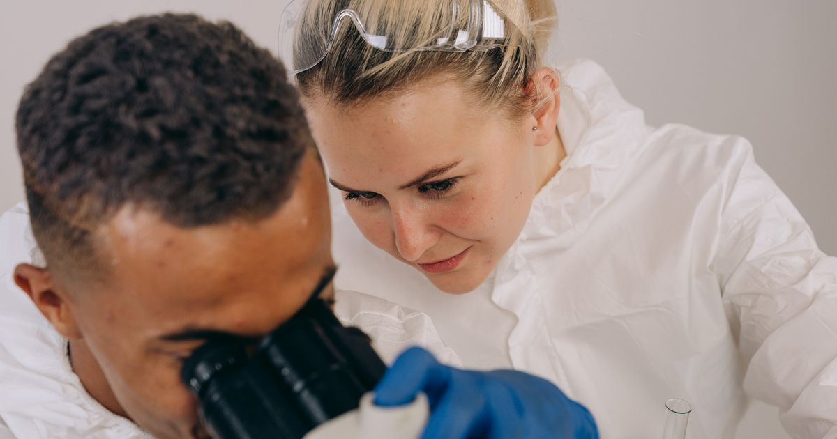 Seattle medical research video production, two researchers at a laboratory microscope